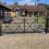 pair of estate gates that have been electrified using an underground motr