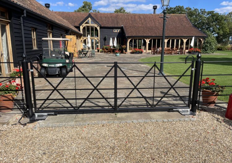 pair of estate gates that have been electrified using an underground motr