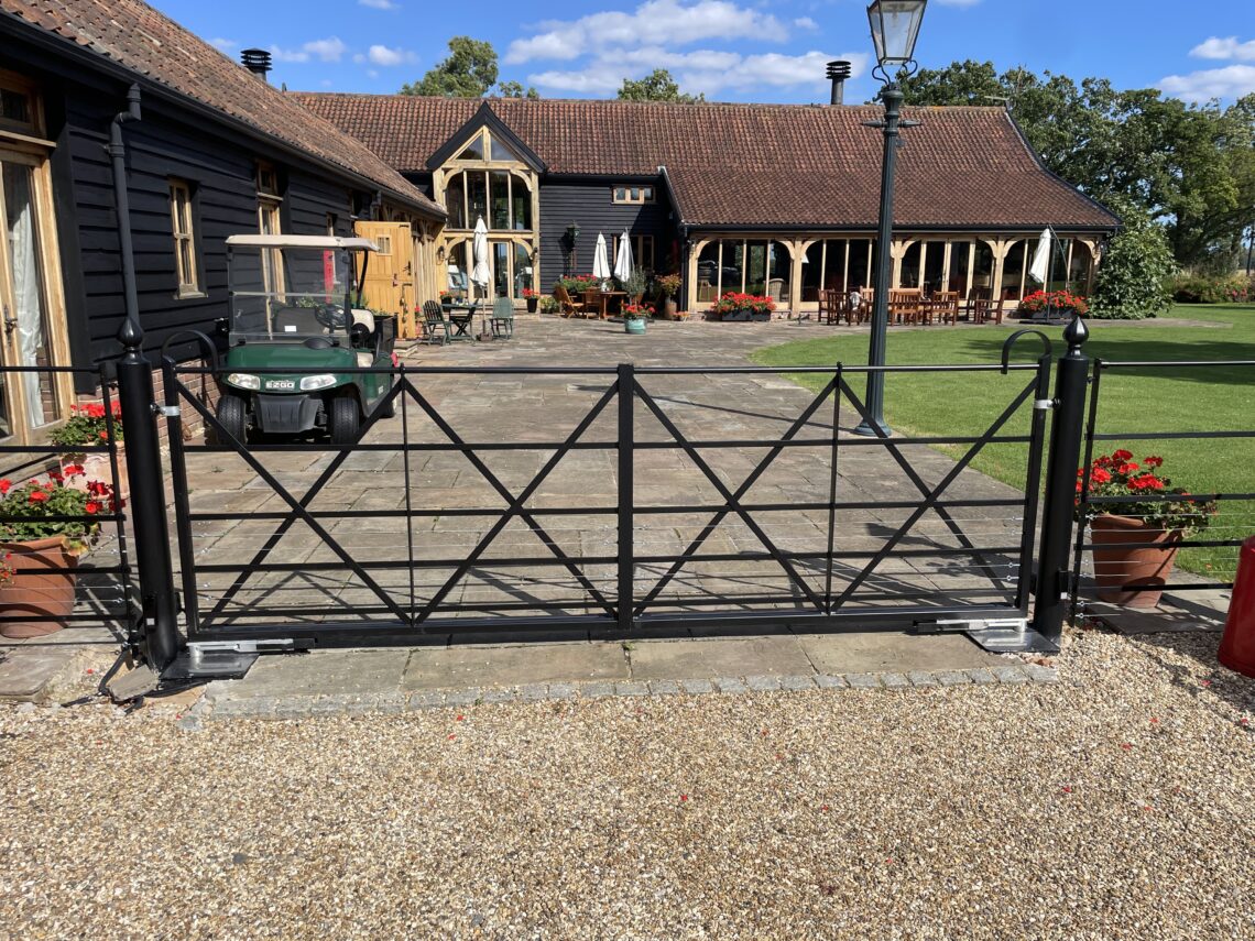 pair of estate gates that have been electrified using an underground motr