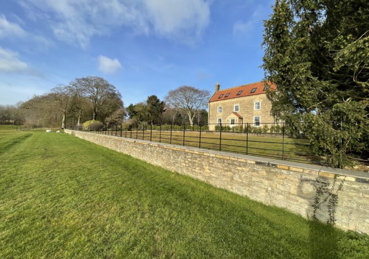 estate fencing behind wall