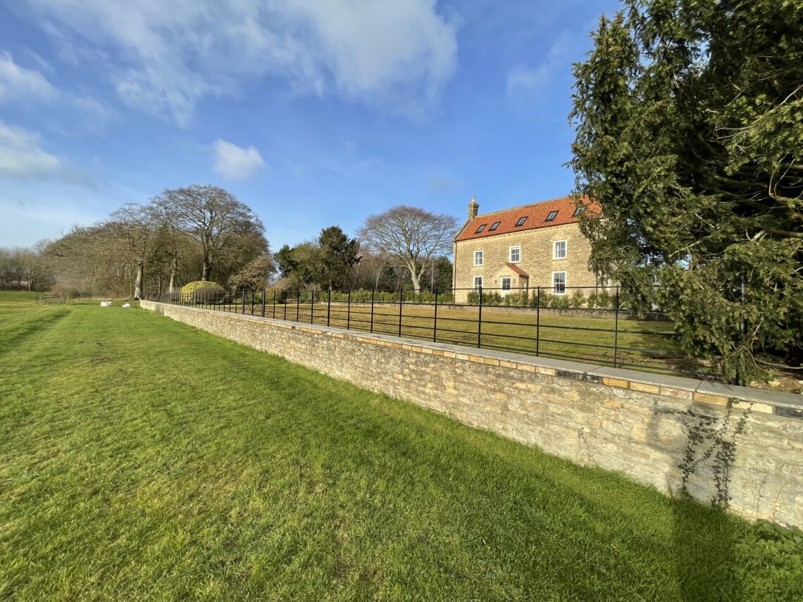 estate fencing behind wall
